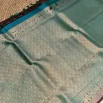Brown checks with blue contrast peacock border silk saree