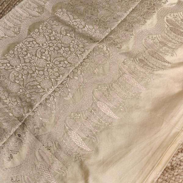 Cream self design motifs rich border and pallu benaras saree